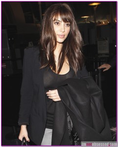 Kim Kardashian arrives at LAX airport with a new haircut featuring bangs
