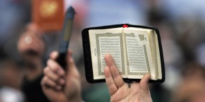 A man holds a copy of the koran aloft at the Islamaphobia rally organised by a coalition of moderate Muslim groups including the Muslim Association of Britain, the UK Islamic Mission and the Islamic Society of Britain in Trafalgar Square, London, Saturday February 11, 2006. Thousands of Muslims will gather today in London to protest at the publication of controversial cartoons caricaturing the Prophet Mohammed. Christian groups are also joining the United Against Incitement and Islamophobia rally in Trafalgar Square to present a united front. See PA Story POLITICS Cartoons. PRESS ASSOCIATION Photo. Photo credit should read: Matt Writtle/PA