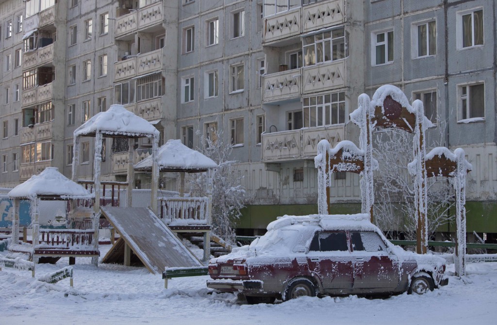 A car covered in ice is pictured near a playground in Yakutsk, in the Republic of Sakha, northeast Russia, February 4, 2013. The coldest temperatures in the northern hemisphere have been recorded in Sakha, the location of the Oymyakon valley, where according to the United Kingdom Met Office a temperature of -67.8 degrees Celsius (-90 degrees Fahrenheit) was registered in 1933 - the coldest on record in the northern hemisphere since the beginning of the 20th century. Yet despite the harsh climate, people live in the valley, and the area is equipped with schools, a post office, a bank, and even an airport runway (albeit open only in the summer).    Picture taken February 4, 2013.    REUTERS/Maxim Shemetov (RUSSIA - Tags: SOCIETY ENVIRONMENT)    ATTENTION EDITORS: PICTURE 4 OF 27 FOR PACKAGE 'THE POLE OF COLD'  SEARCH 'MAXIM COLD' FOR ALL IMAGES
