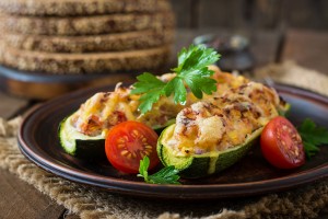 Stuffed zucchini with chicken, tomatoes and onion with cheese crust