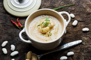 Creamy white bean soup on wooden background