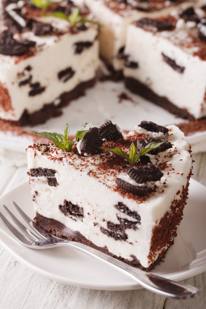 piece of cheesecake with chocolate cookies closeup. vertical