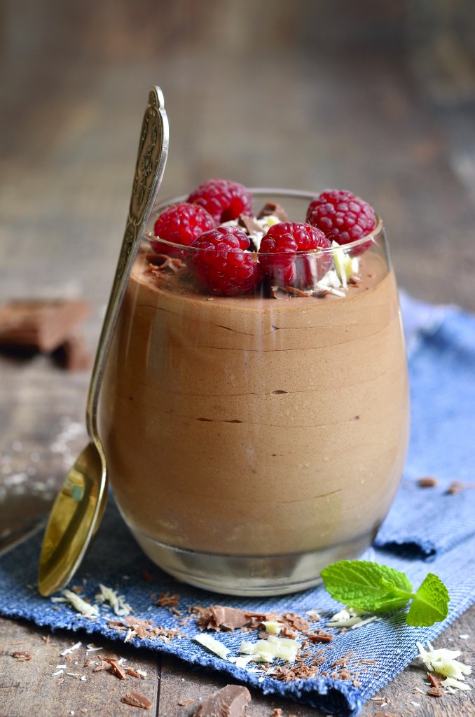 Chocolate mousse with raspberry in a glass.Rustic style.