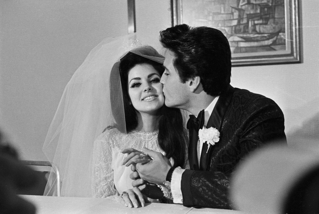 (Original Caption) 5/1/1967-Las Vegas, NV: Elvis Presley gives his new bride, Priscilla Ann Beaulieu, a kiss following their wedding. The bride wears a large diamond on her finger.