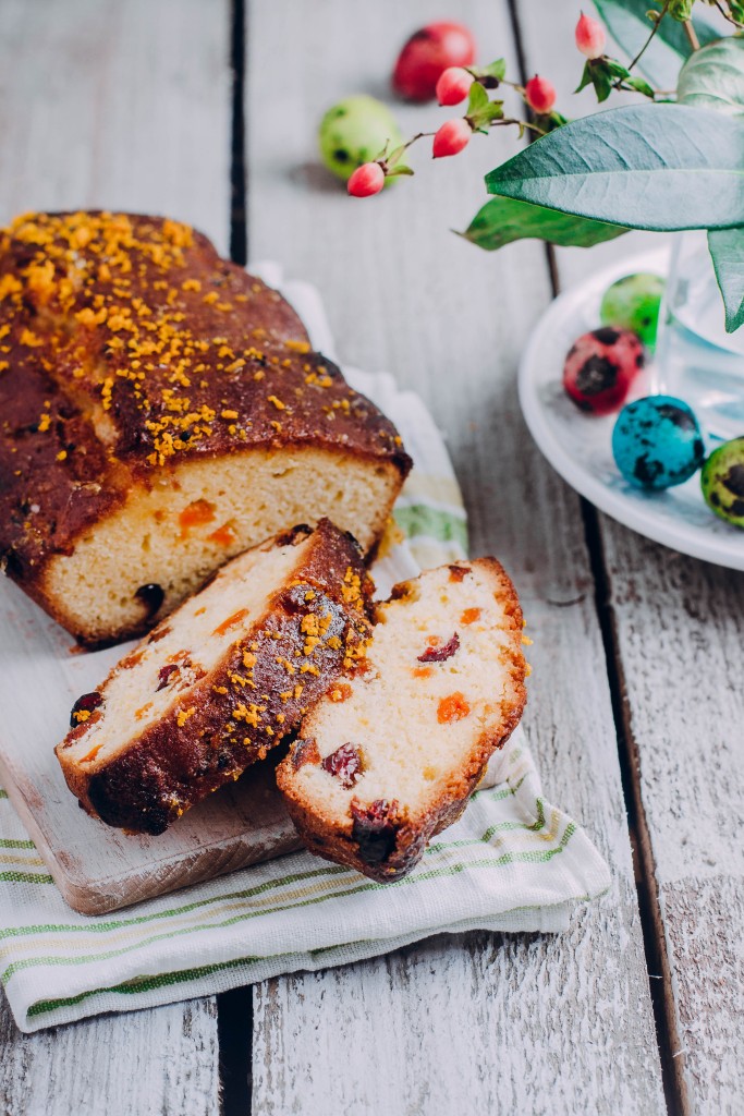 Easter citrus cake with dried fruits for holiday on wooden table background. Copy space, vertical, image