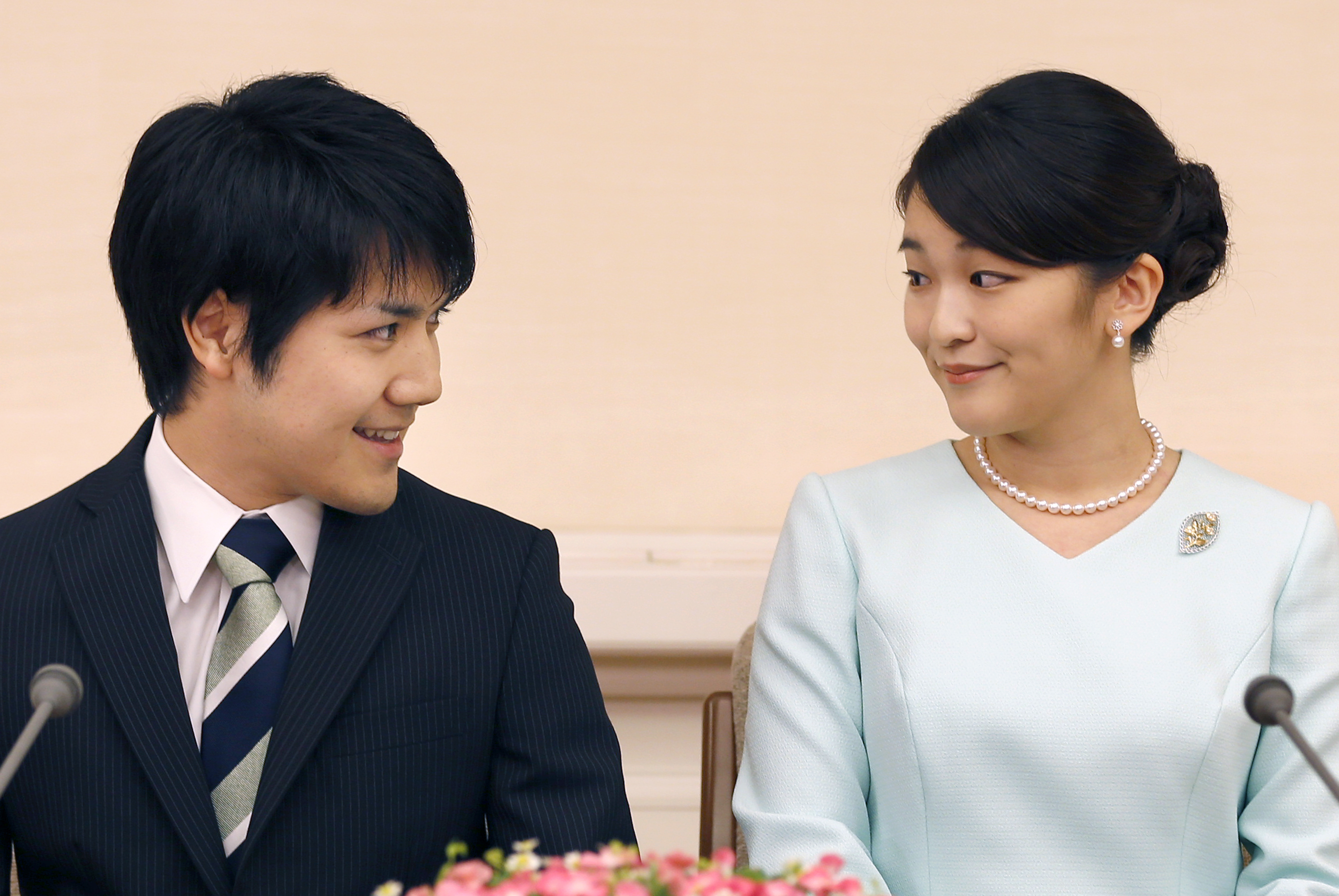 Japan's Princess Mako, right, the elder daughter of Prince Akishino and Princess Kiko, and her fiance Kei Komuro, look at each other during a press conference at Akasaka East Residence in Tokyo, Sunday, Sept. 3, 2017. Japanese Emperor Akihito's oldest grandchild, Princess Mako, says she is getting married to her university classmate who won her heart with bright smiles and sincerity.(AP Photo/Shizuo Kambayashi, Pool)