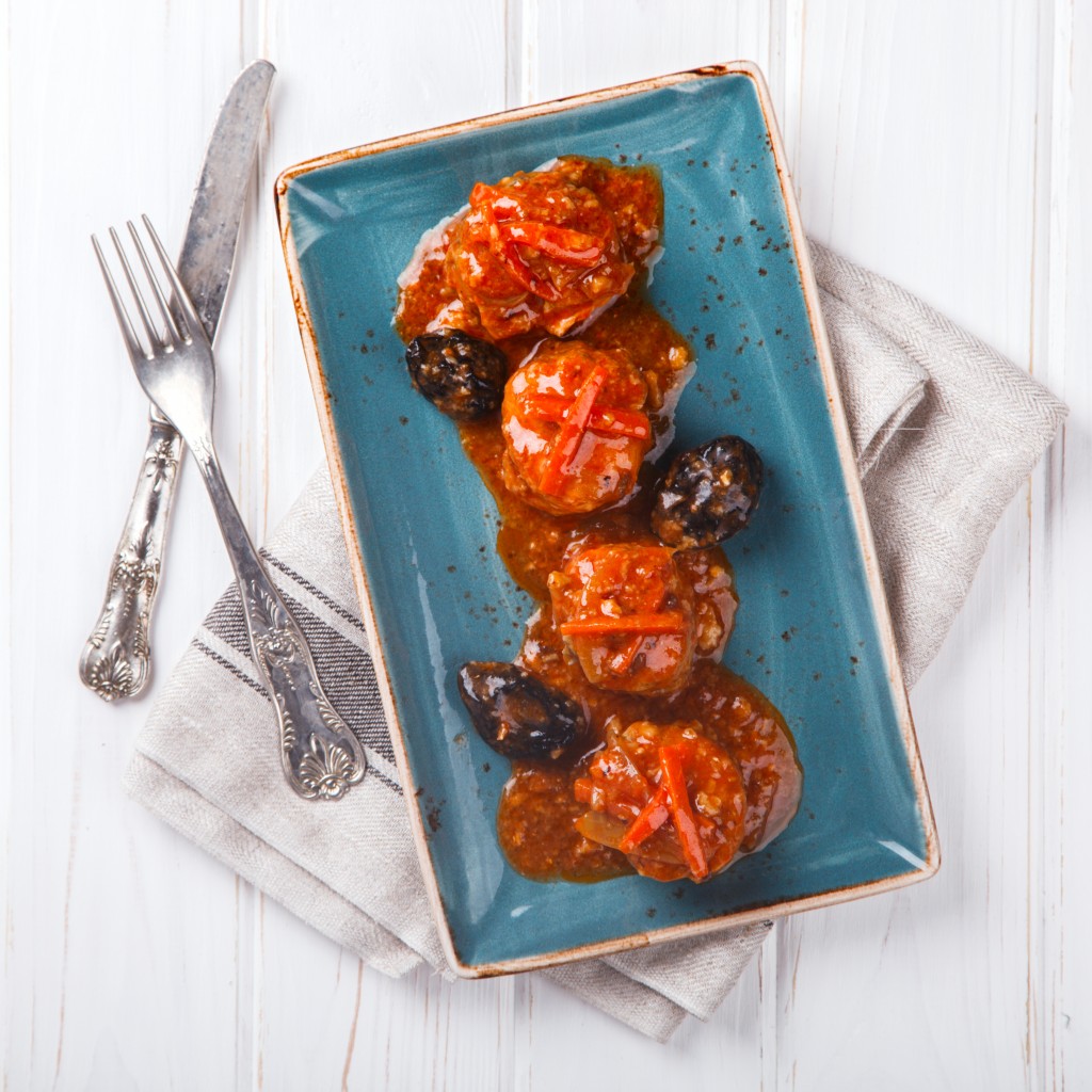 Fish,Chicken,Meatballs in tomato sauce with Prunes and carrots.selective focus.